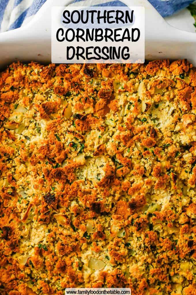 Browned cornbread dressing in a white casserole dish with a text overlay on the photo