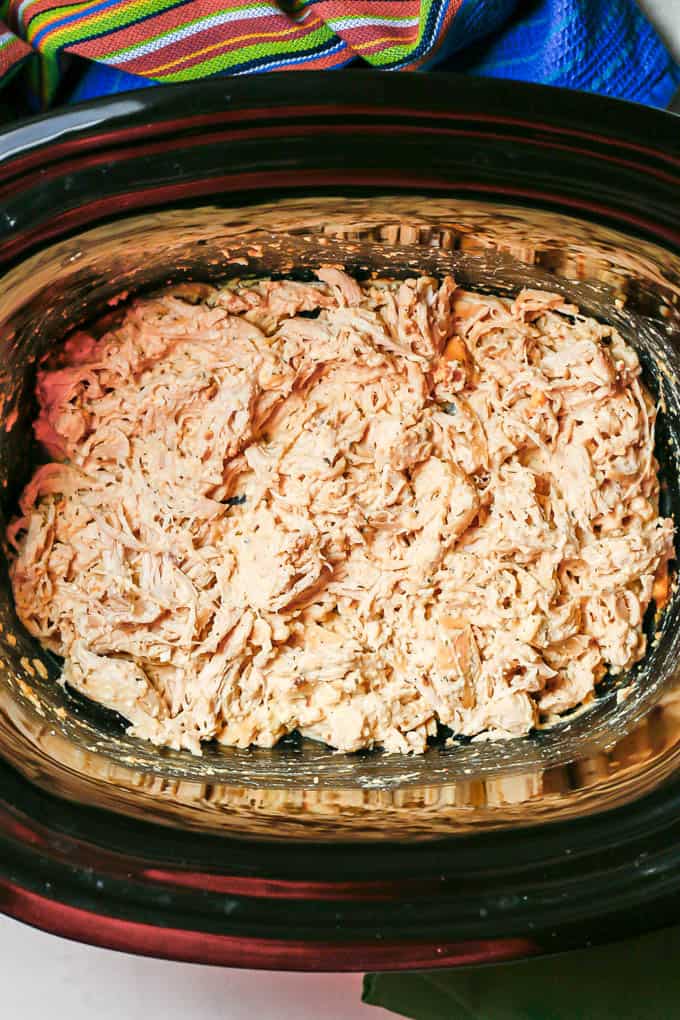 Creamy shredded chicken in a slow cooker.