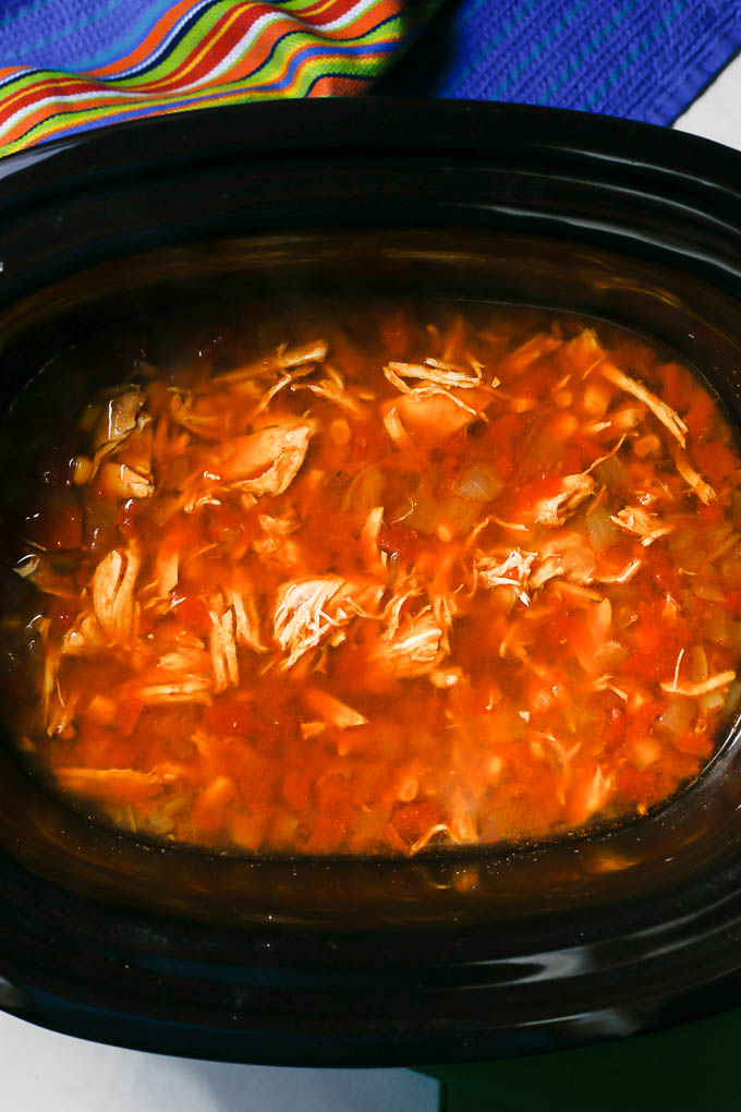 Slow cooker chicken tortilla soup in an insert before being served