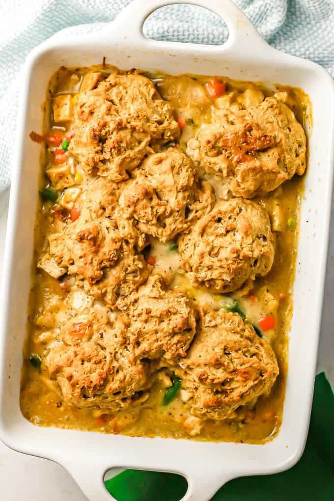 Turkey pot pie with browned drop biscuits on top baked in a white rectangular casserole dish