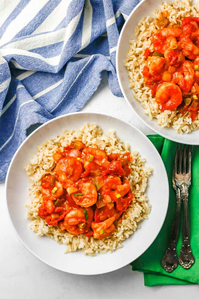 Shrimp creole served over rice in two low white bowls.