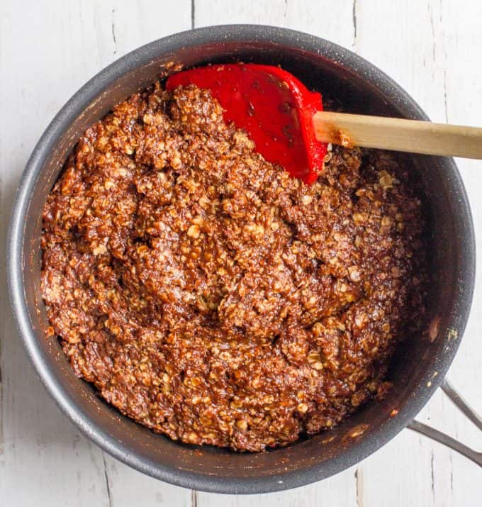 A chocolate peanut butter oat mixture being stirred together in a large pot.