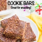 Close up of thick, chocolatey healthy no bake cookie bars on a white plate set on a yellow napkin with a text overlay on the photo.