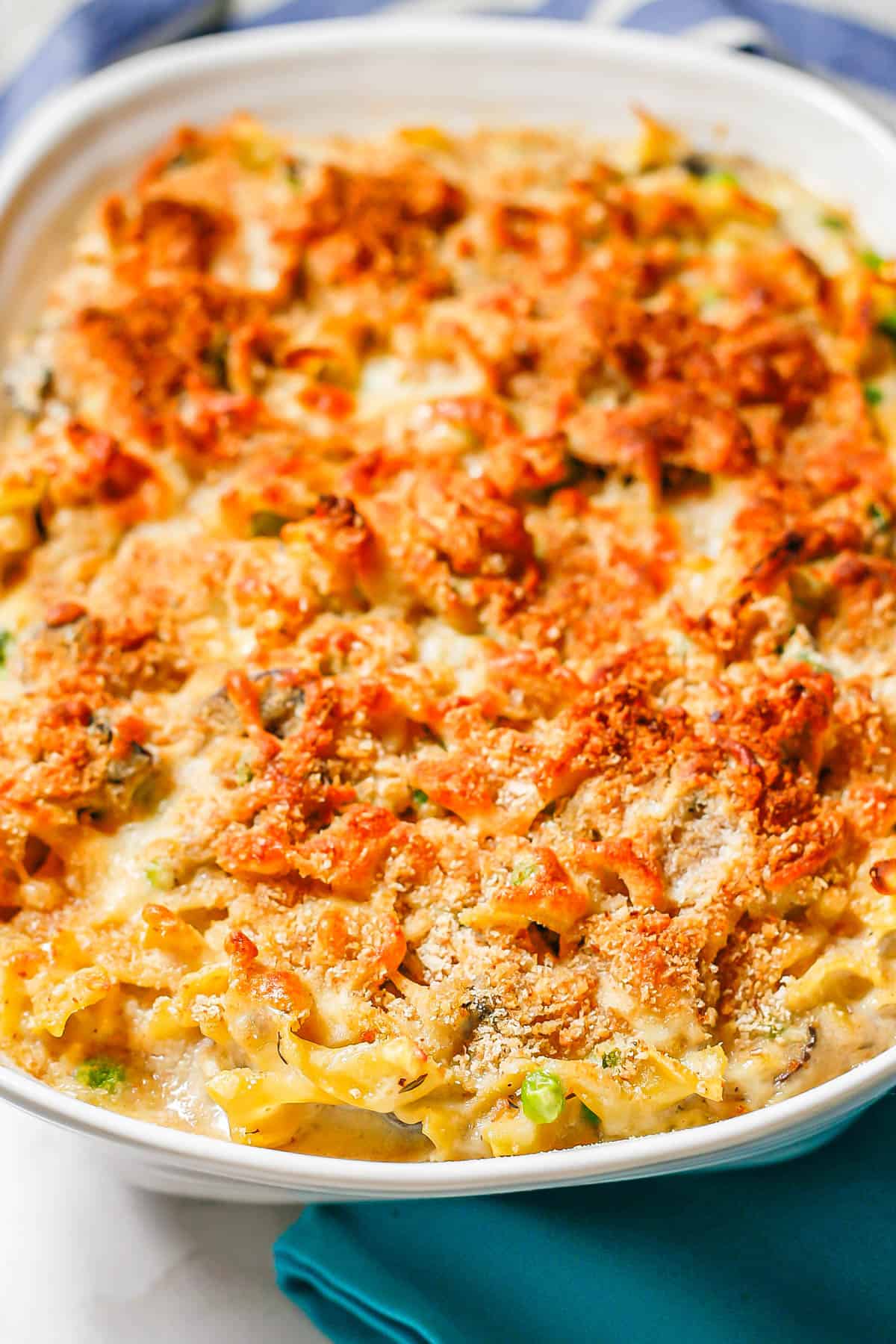 Baked tuna noodle casserole in a white rectangular casserole dish before being served.