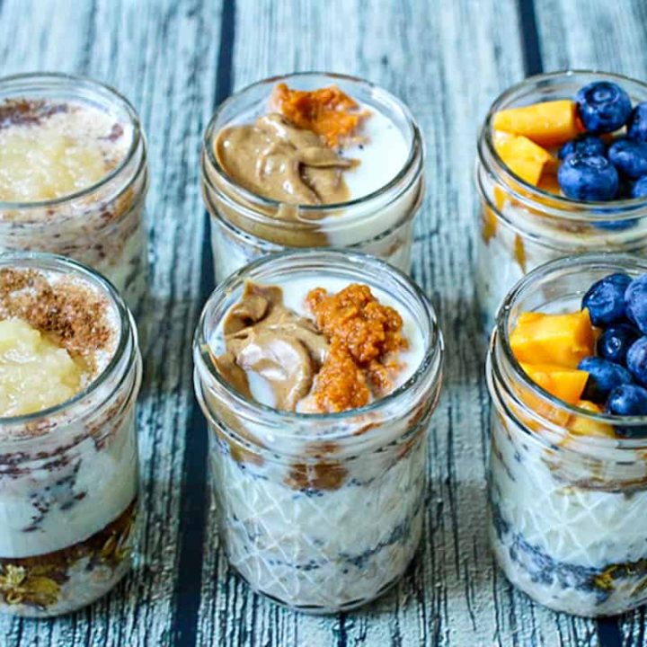 Six glass jars of overnight oats with different topping combinations.