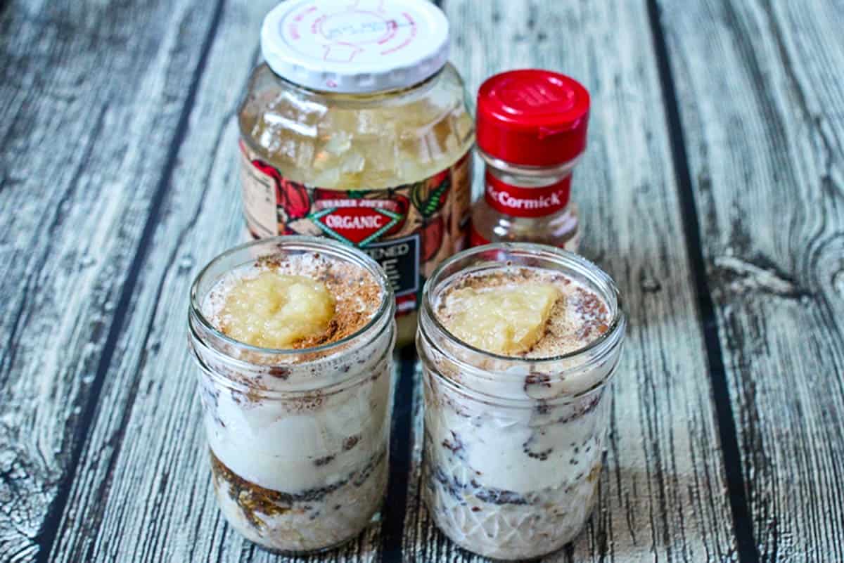 Two glass jars with applesauce cinnamon overnight oats.