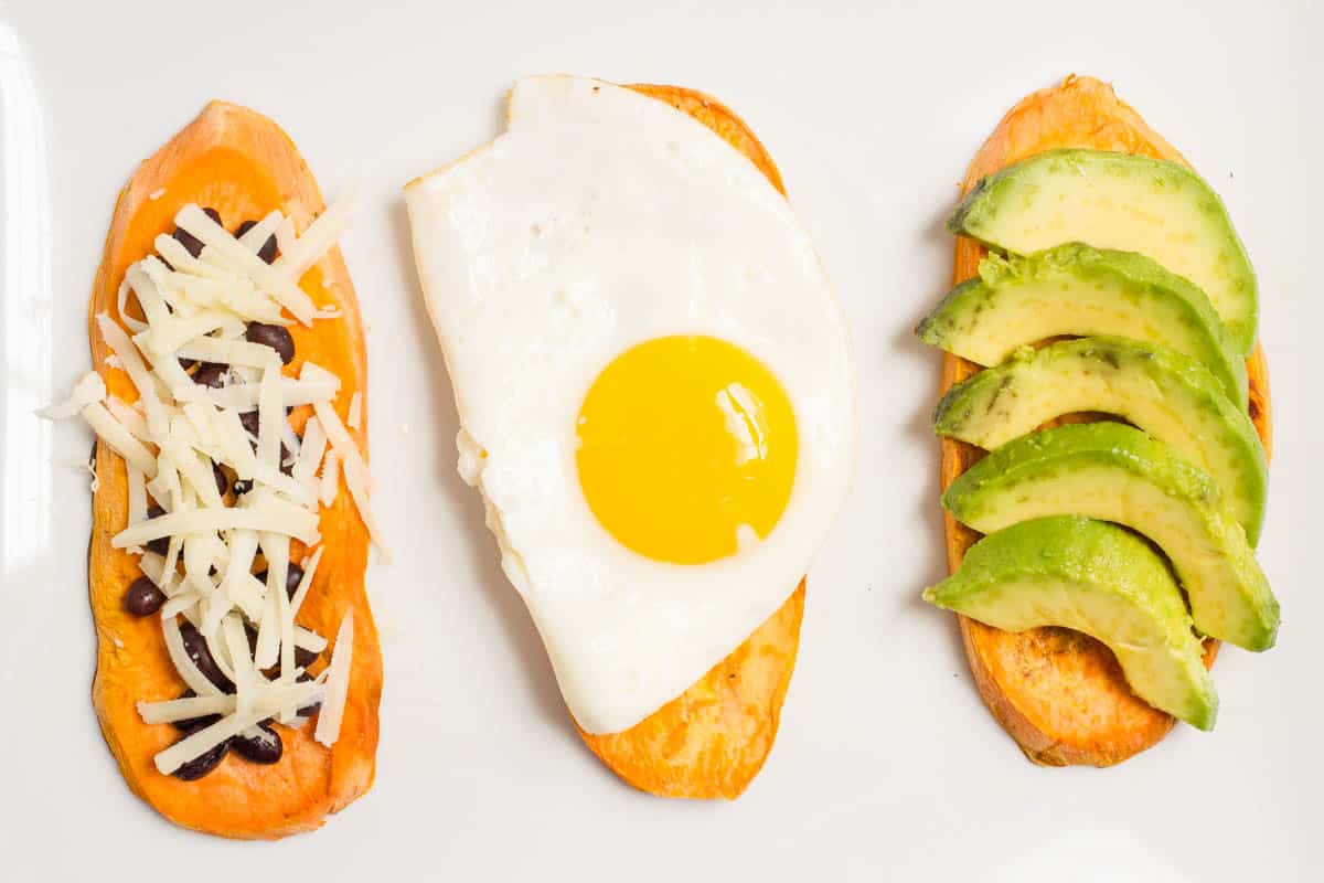 Three slices of sweet potato toast with different savory toppings.