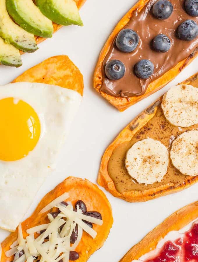 Close up of sweet potato toast slices on a white plate with different sweet and savory toppings.