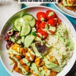 A low white bowl with caulifower rice, turmeric chicken, fresh veggies and a tahini herb dressing drizzled over top and a text overlay on the photo.