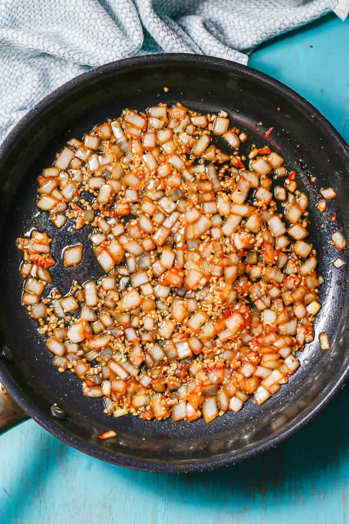 Sautéed onion and garlic in a large dark skillet.