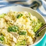 Spaghetti squash with chicken and broccoli topped with Parmesan cheese served in a low white bowl with two forks resting in it and a text overlay on the photo.