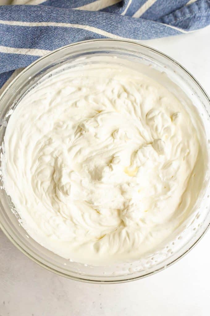 Homemade whipped cream in a large glass bowl.