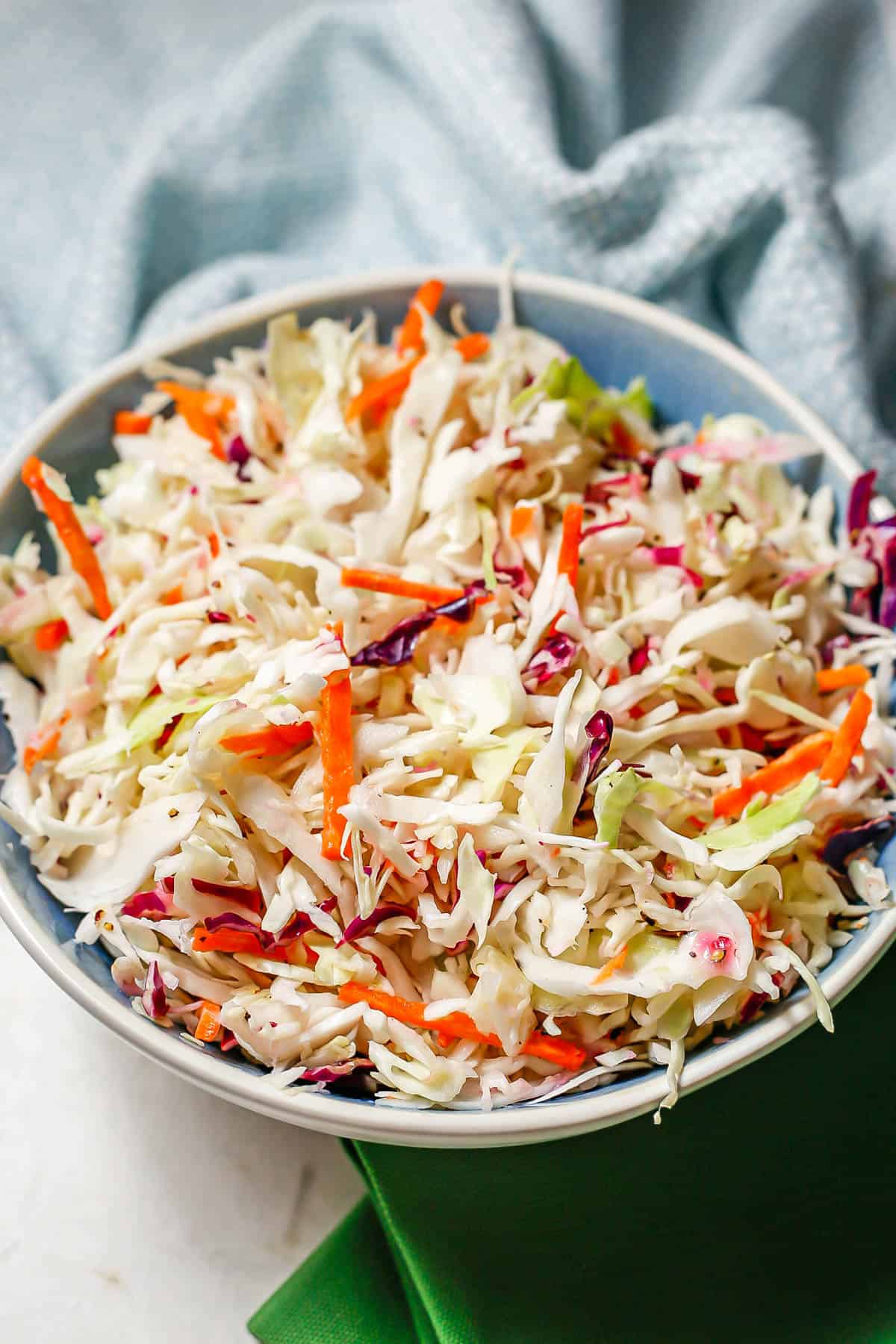 Homemade coleslaw mix served in a large blue and white bowl.