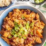 Honey garlic chicken served in a blue and white bowl with sliced green onions on top and to the side and a bowl of rice to the side and a text overlay on the photo.