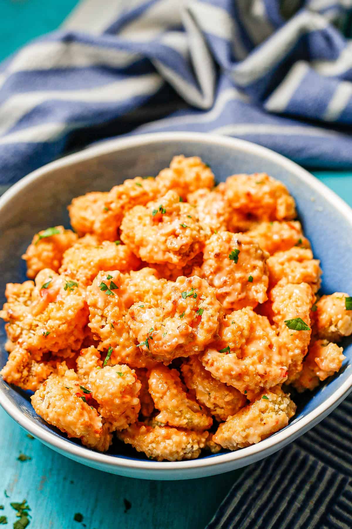 Bang bang shrimp in a blue and white bowl.