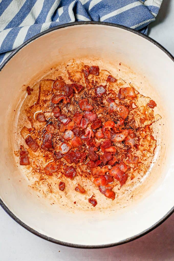 Chopped bacon cooked in a large deep pot.