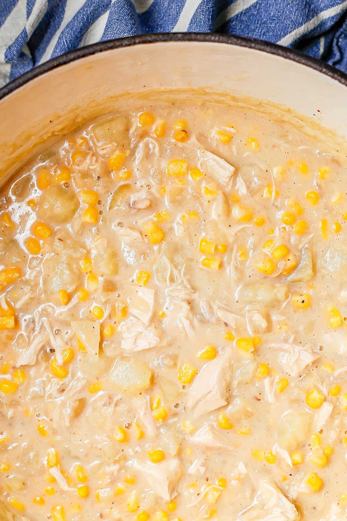 Close up of a creamy chicken corn chowder in a large deep pot.