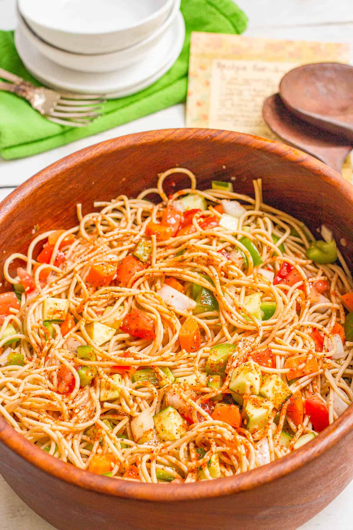 Spaghetti salad with tomatoes, carrots, green peppers and cucumber with Italian dressing and salad seasoning.