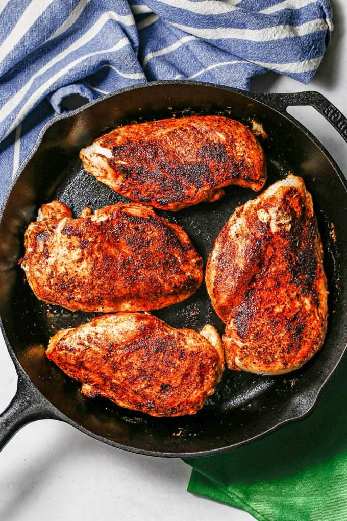 Seared chicken breasts in a cast iron pan.