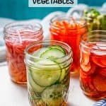Small glass mason jars with different pickled vegetables with a text overlay on the photo.