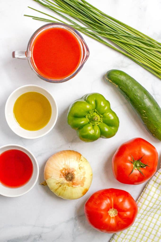 Ingredients laid out on a counter for making homemade gazpacho.