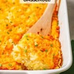 A wooden spatula lifting out a square of cheesy hash brown casserole from a white rectangular dish with a text overlay on the photo.