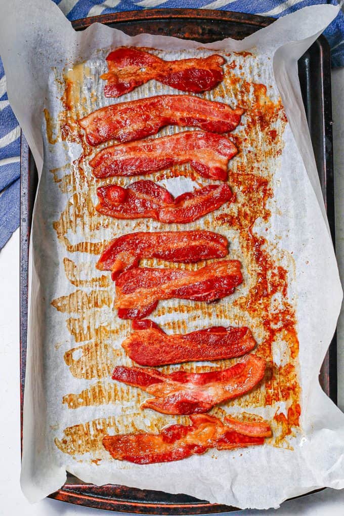Cooked bacon in the oven on a baking sheet.