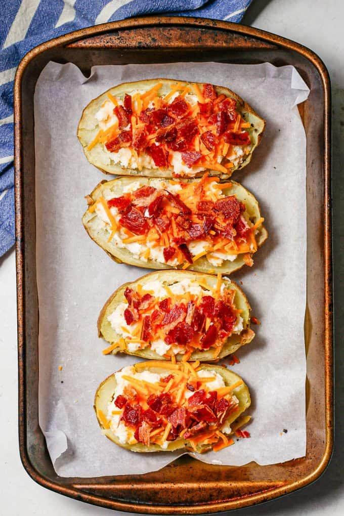 Stuffed potatoes topped with cheese and bacon before being baked again.