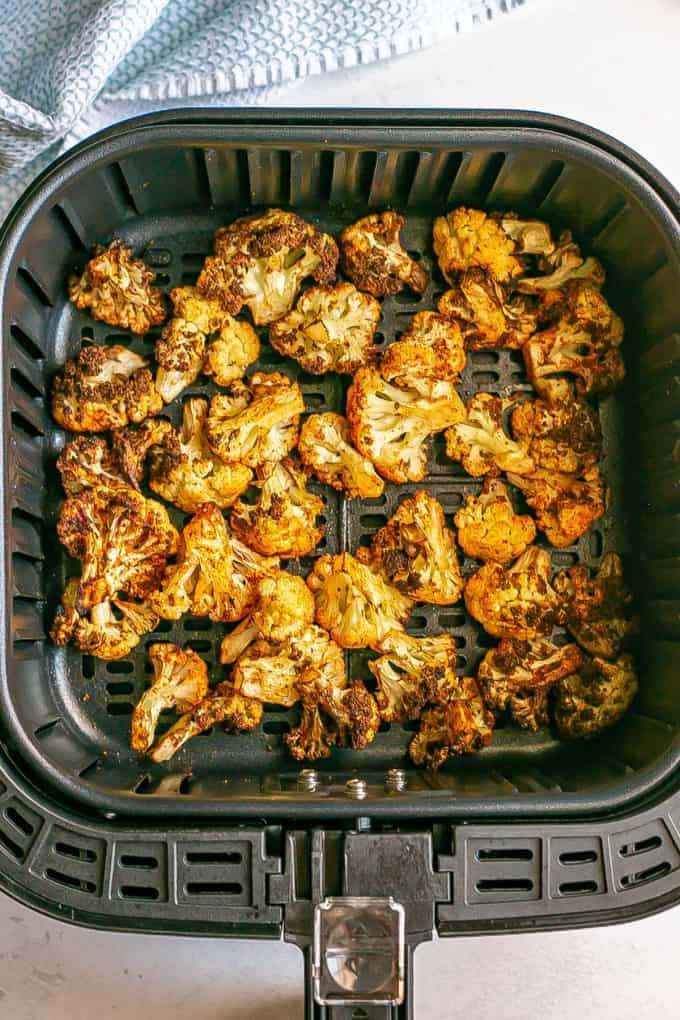 Browned cauliflower florets cooked in an Air Fryer.