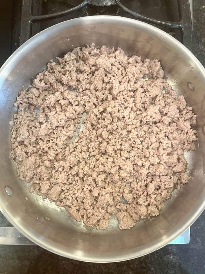 Cooked ground turkey in a large deep skillet.