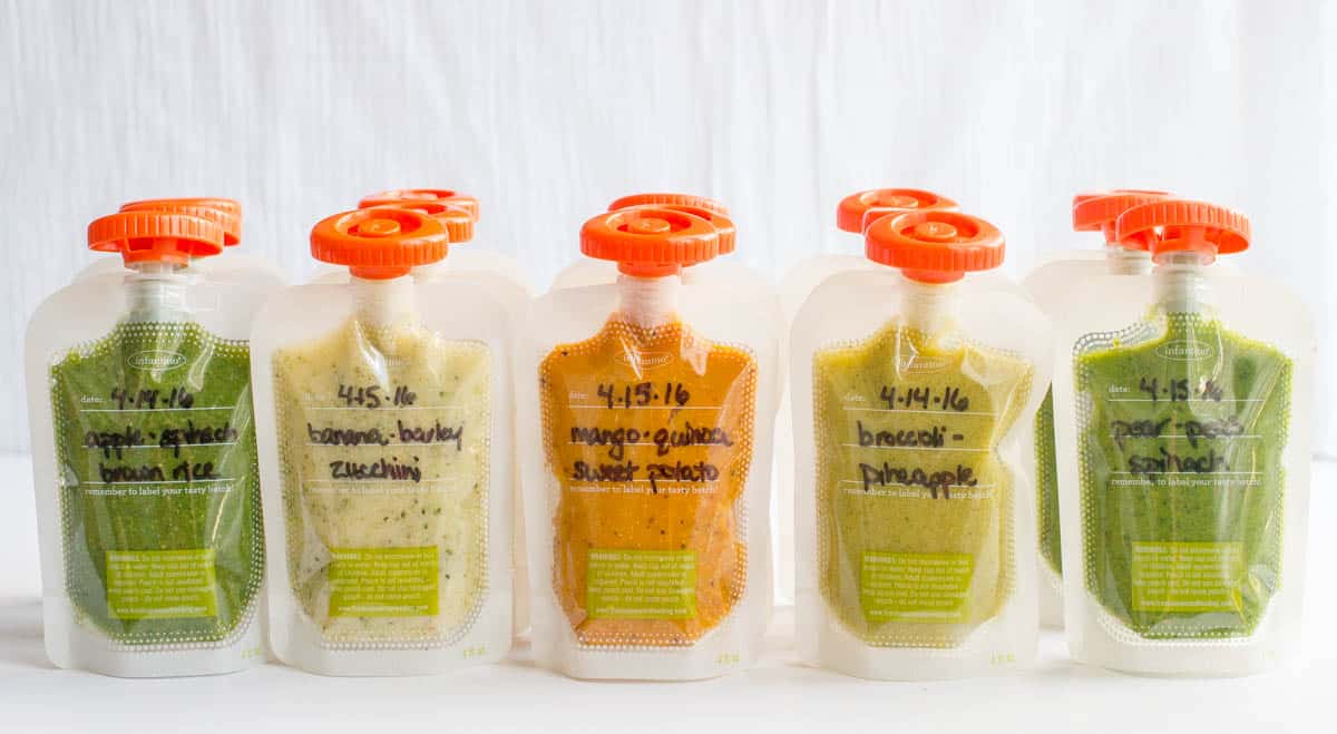 Rows of homemade baby food pouches with the names of the different combinations written on the front.