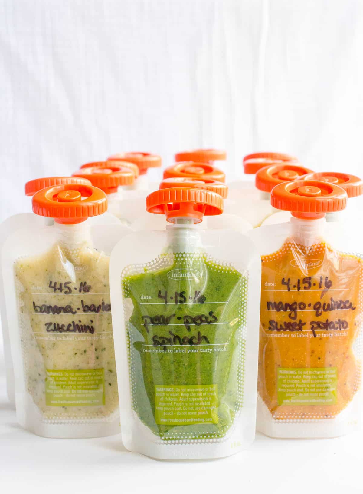 Homemade baby food squeeze pouches with the names of the different combinations written on the front.