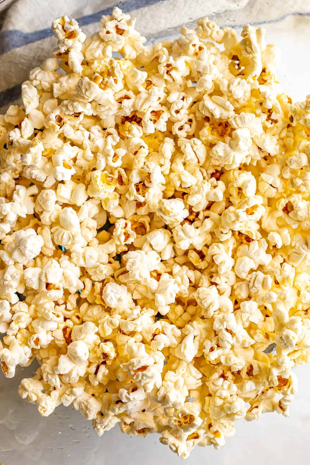 Close up of popcorn in a large glass bowl.