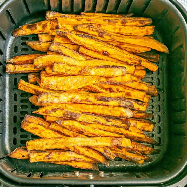 Close up of sweet potato fries in an Air Fryer tray after being cooked.