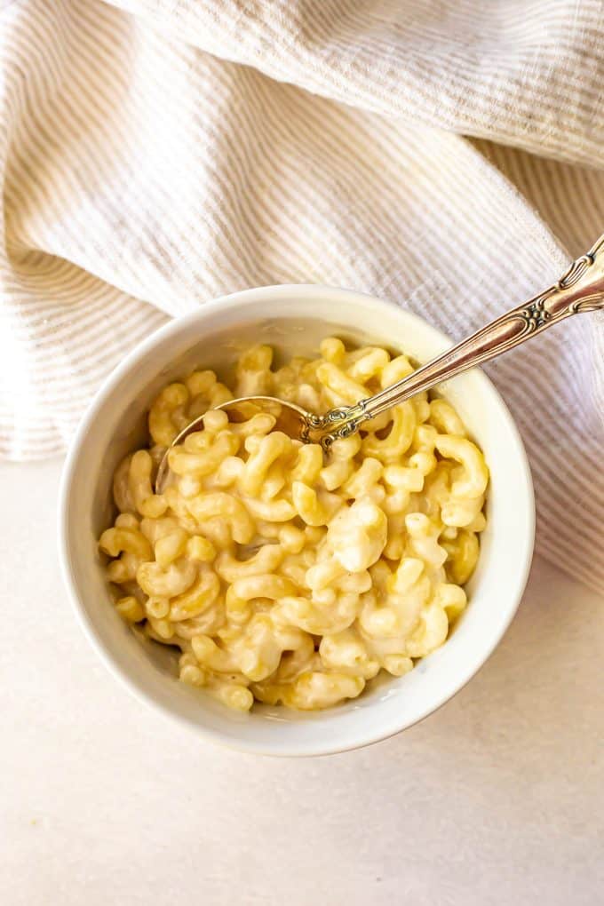 Microwave mac and cheese served in a small white bowl.