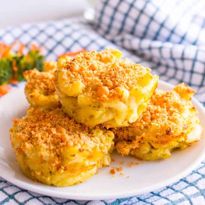 A small white plate with a stack of veggie mac and cheese muffins with a breadcrumb topping on each.