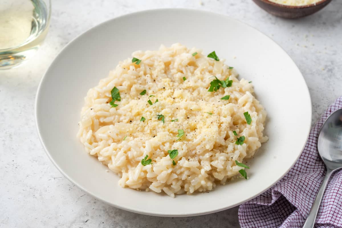 Risotto topped with Parmesan cheese, black pepper and chopped fresh parsley.