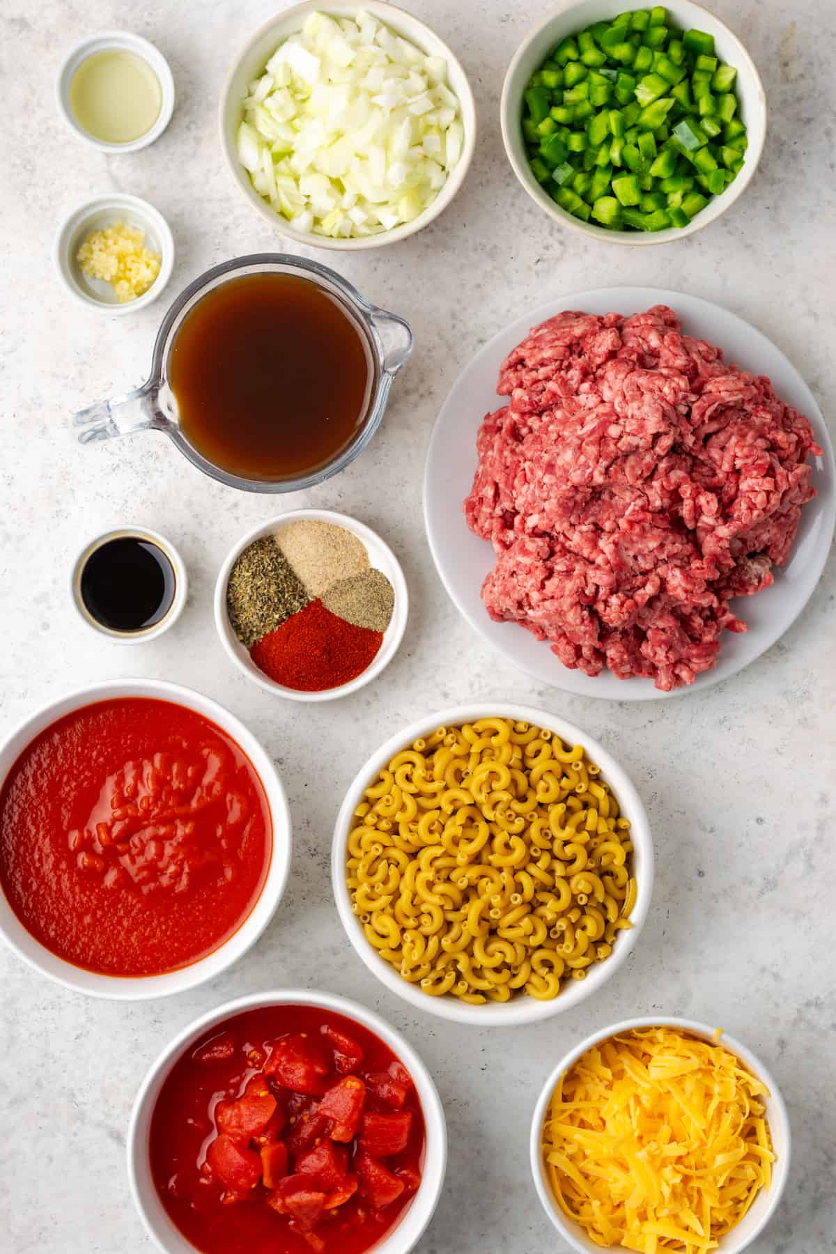 Ingredients laid out in separate bowls for making American style goulash.