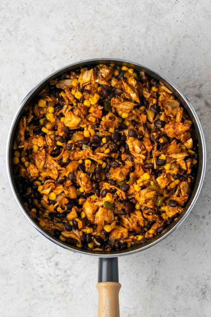 A chicken and black bean mixture with corn in a large skillet.