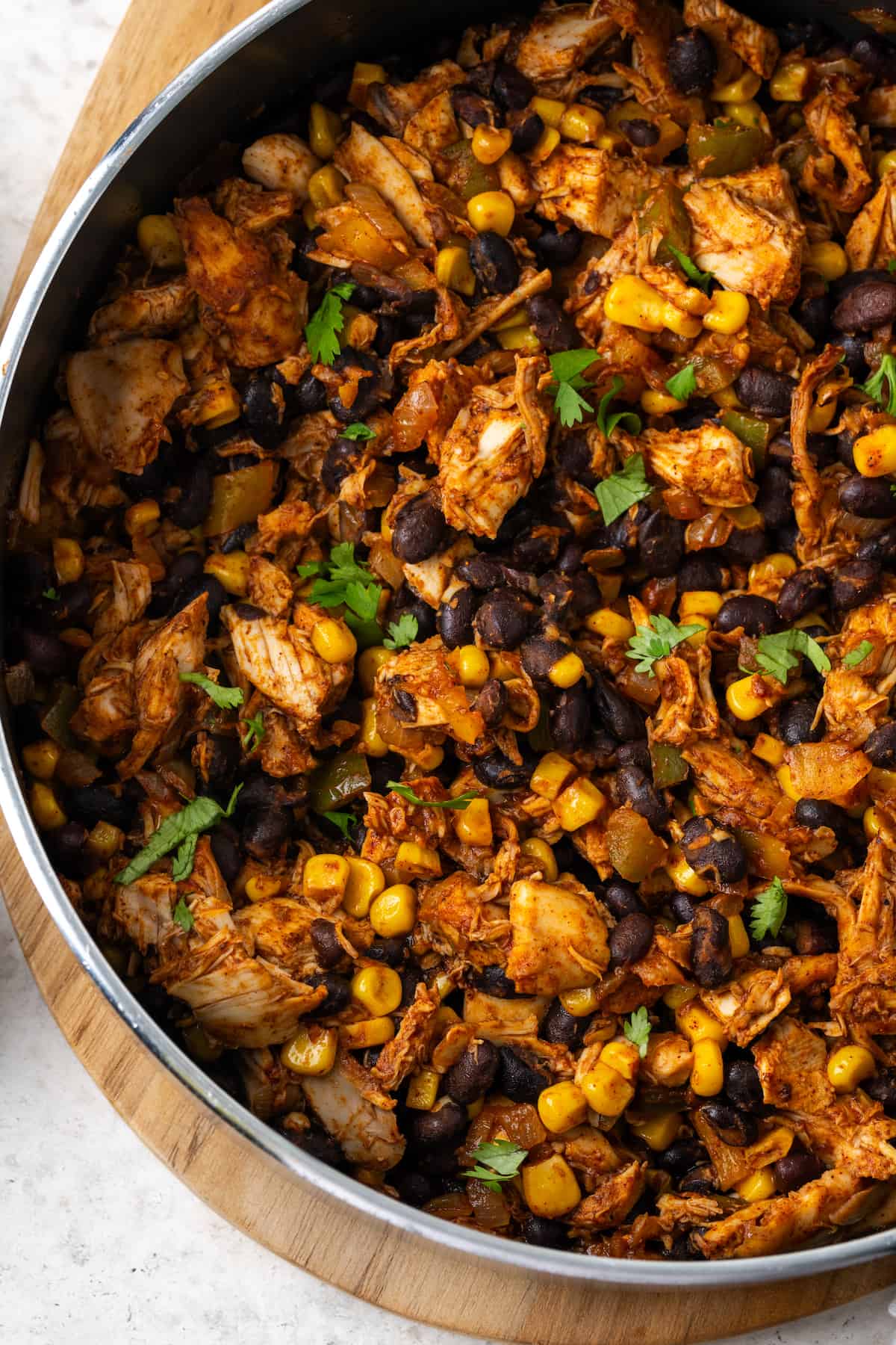 A southwest chicken skillet with black beans and corn in a large pan.