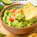 A chip scooping up some guacamole from a serving bowl with a text overlay on the photo.
