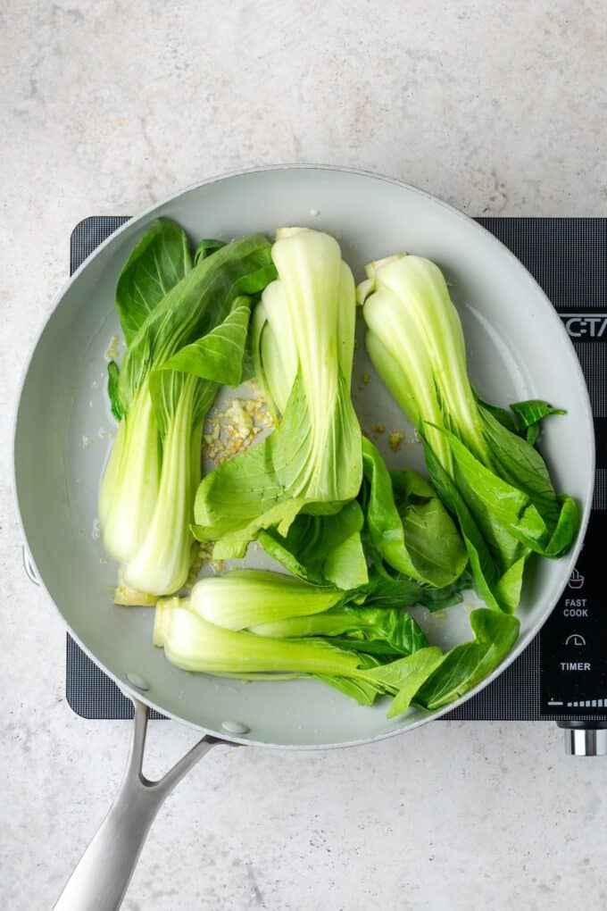 Sliced bok choy in a large skillet.