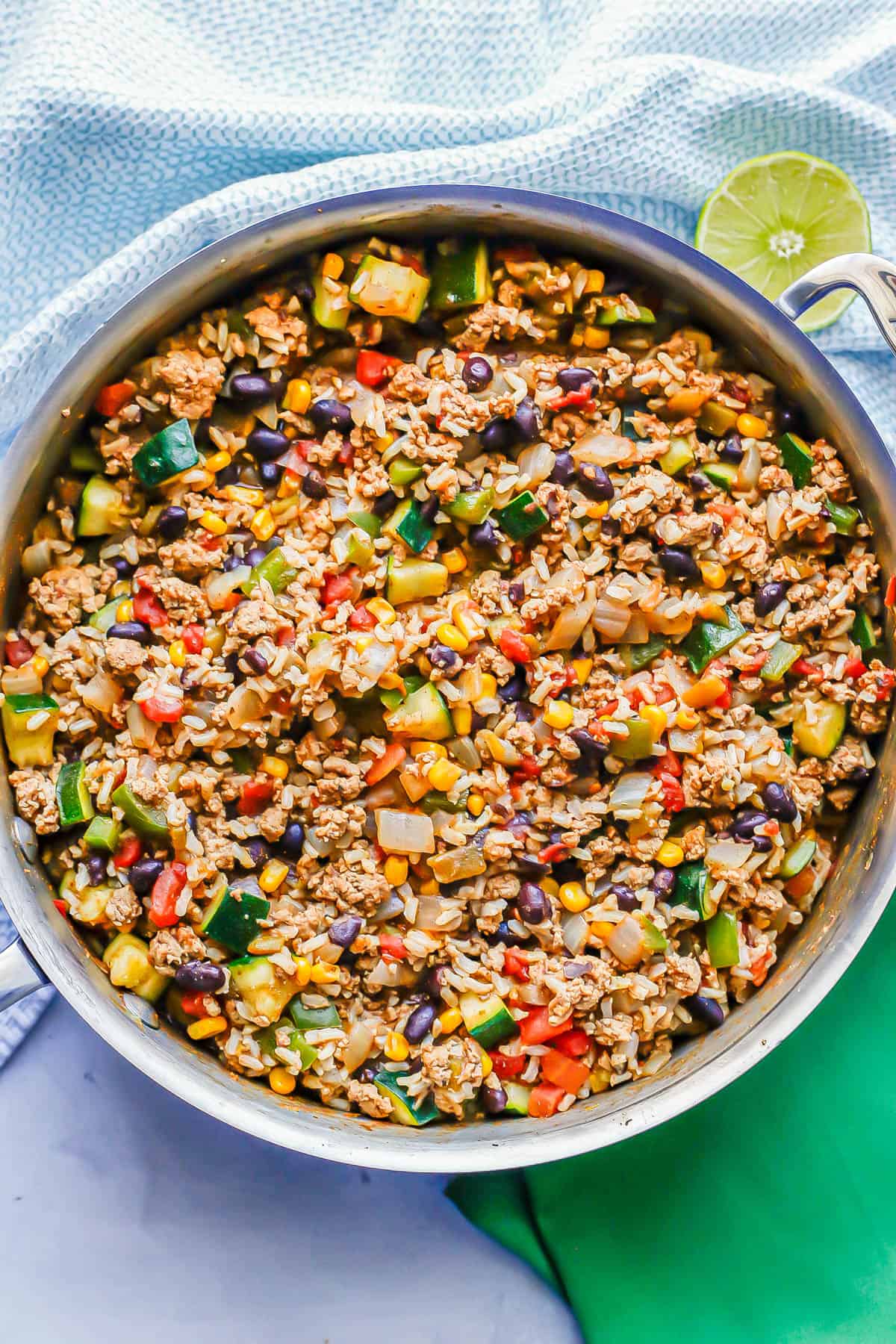 Ground turkey with rice, beans and vegetables in a large deep skillet.