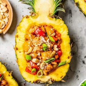 Close up of pineapple chicken with bell pepper, cashews and sesame seeds.