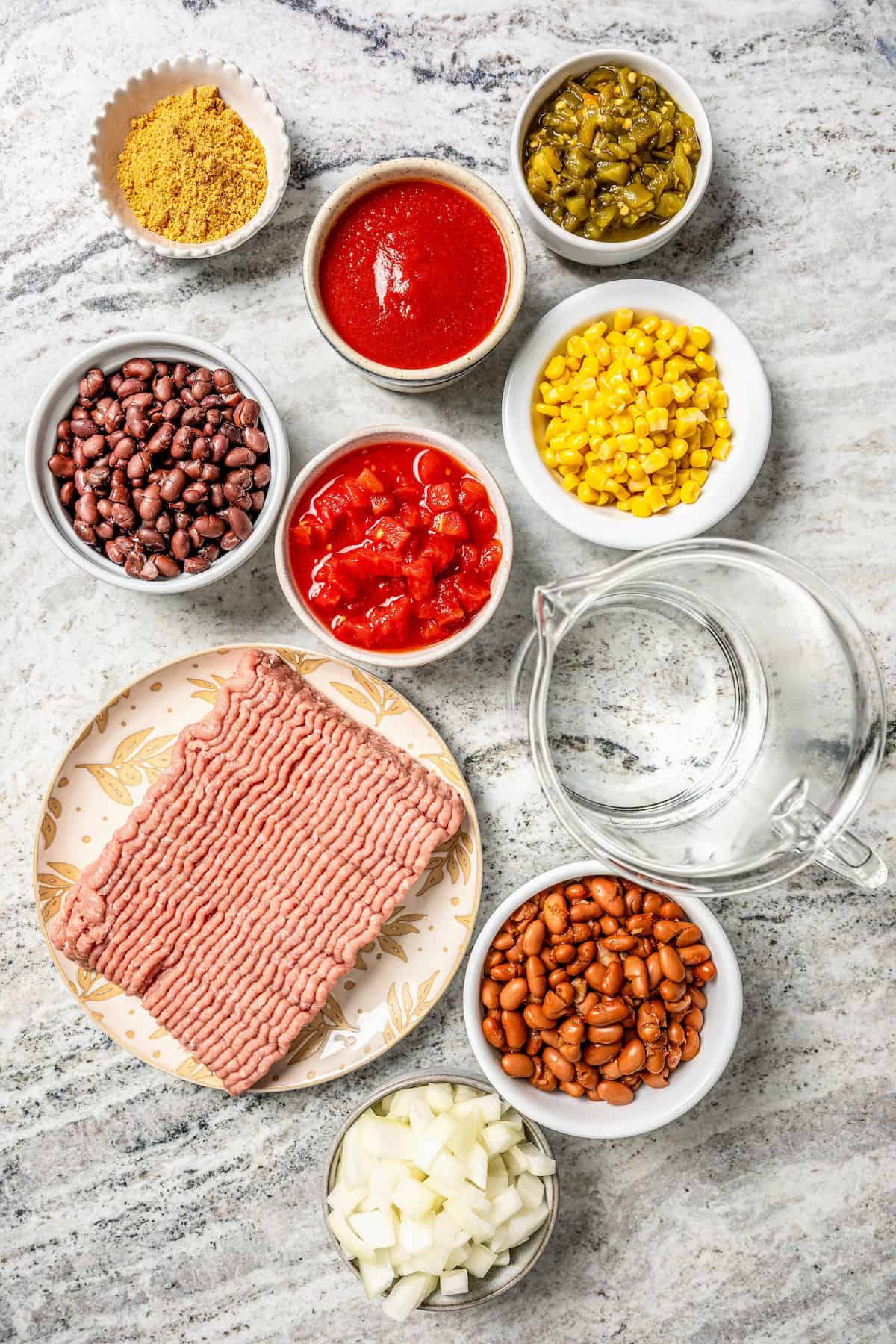 Ingredients laid out in separate bowls on a counter for making taco soup.