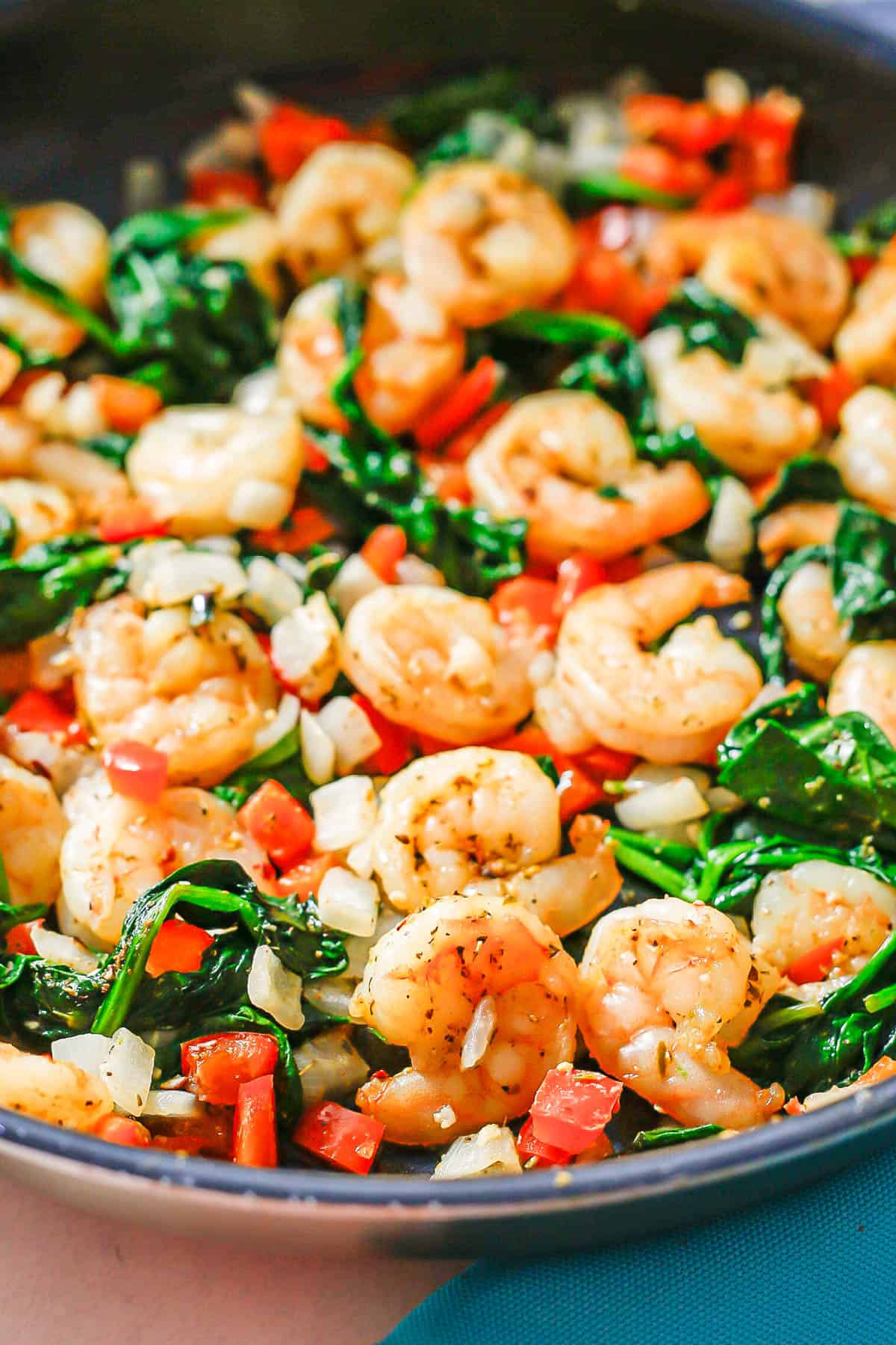 Close up of a Mediterranean style shrimp mixture in a skillet.