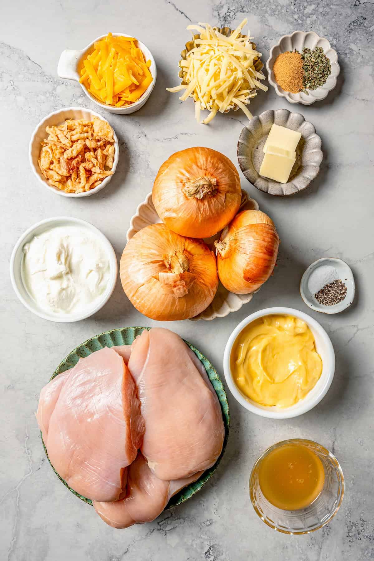 Ingredients laid out in separate bowls for making a French onion chicken recipe.