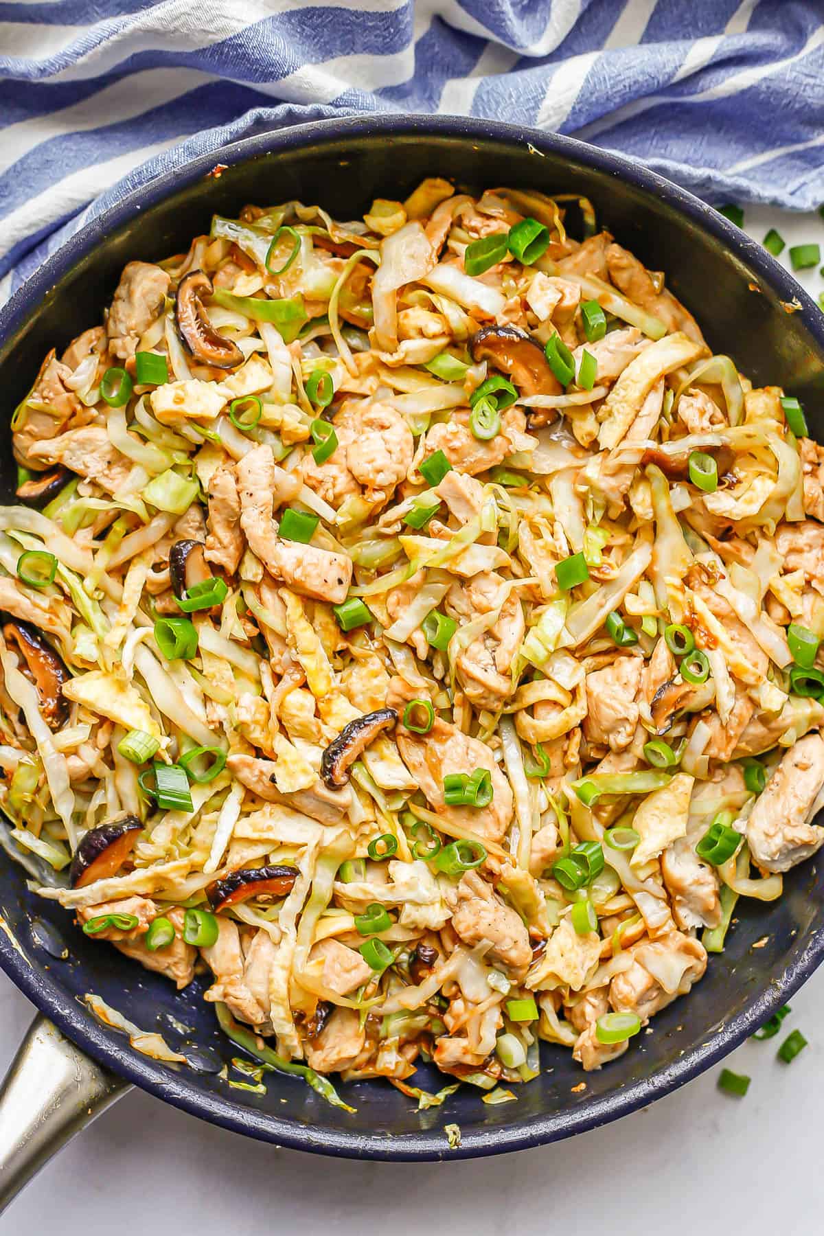 A large skillet with a homemade moo shu chicken mixture.