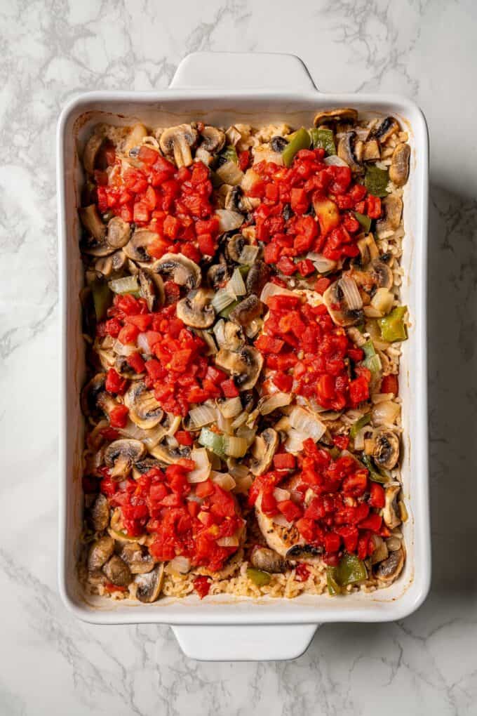 Baked pork chop casserole with rice and vegetables in a rectangular white baking dish.