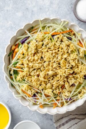 Crunchy raw ramen noodles atop a broccoli coleslaw mixture with peanuts.